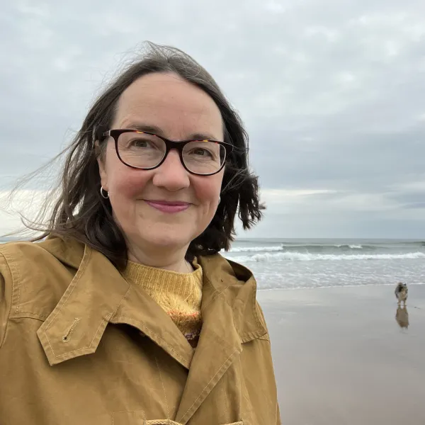 Alice walking on Spittal beach in Northumberland with her Sheltie